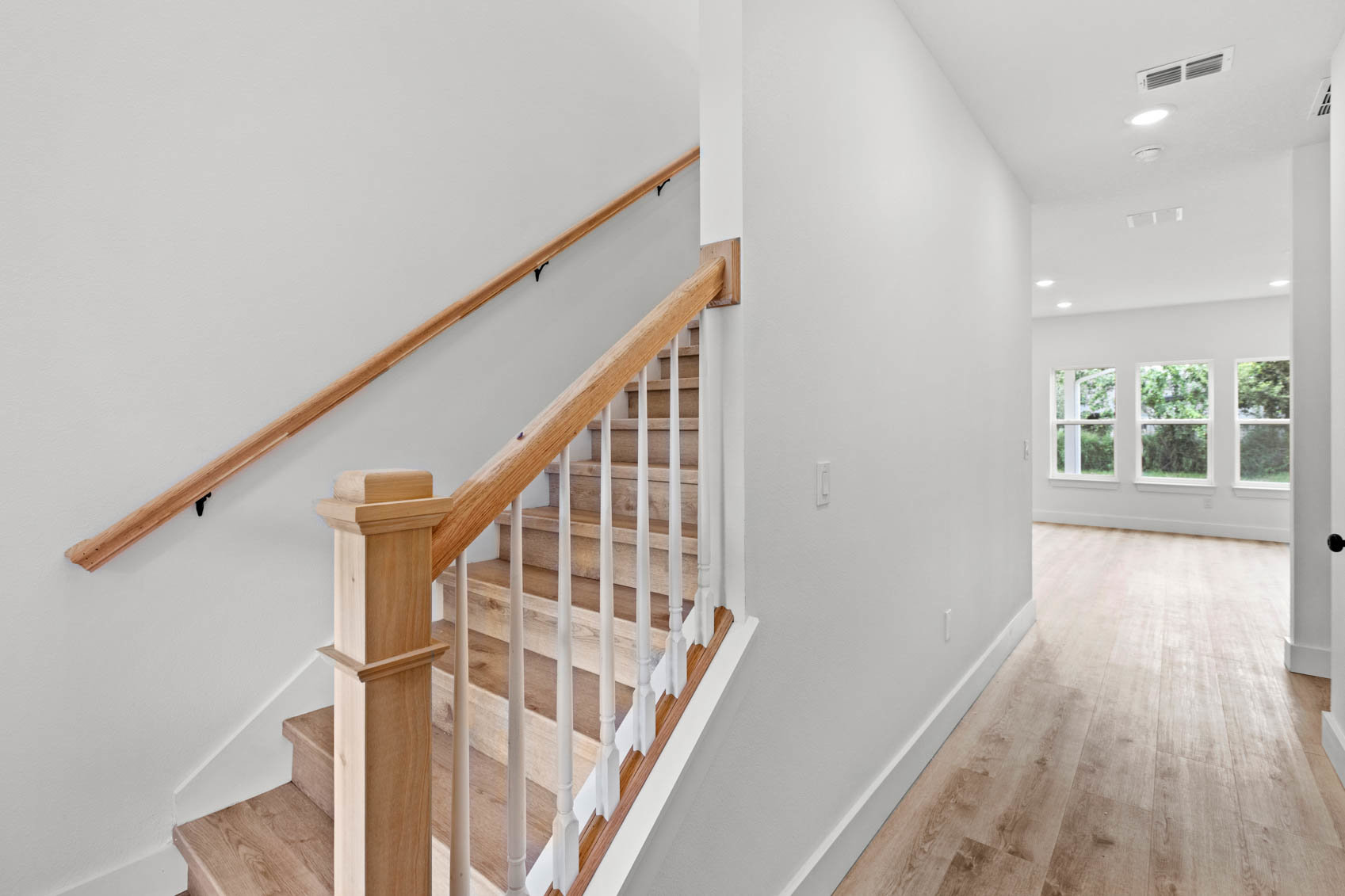 front stairs with white hallway to living room